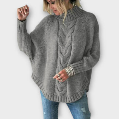 Knitted sweater with cable pattern